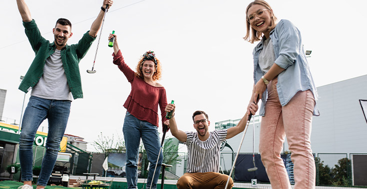 People playing mini-golf